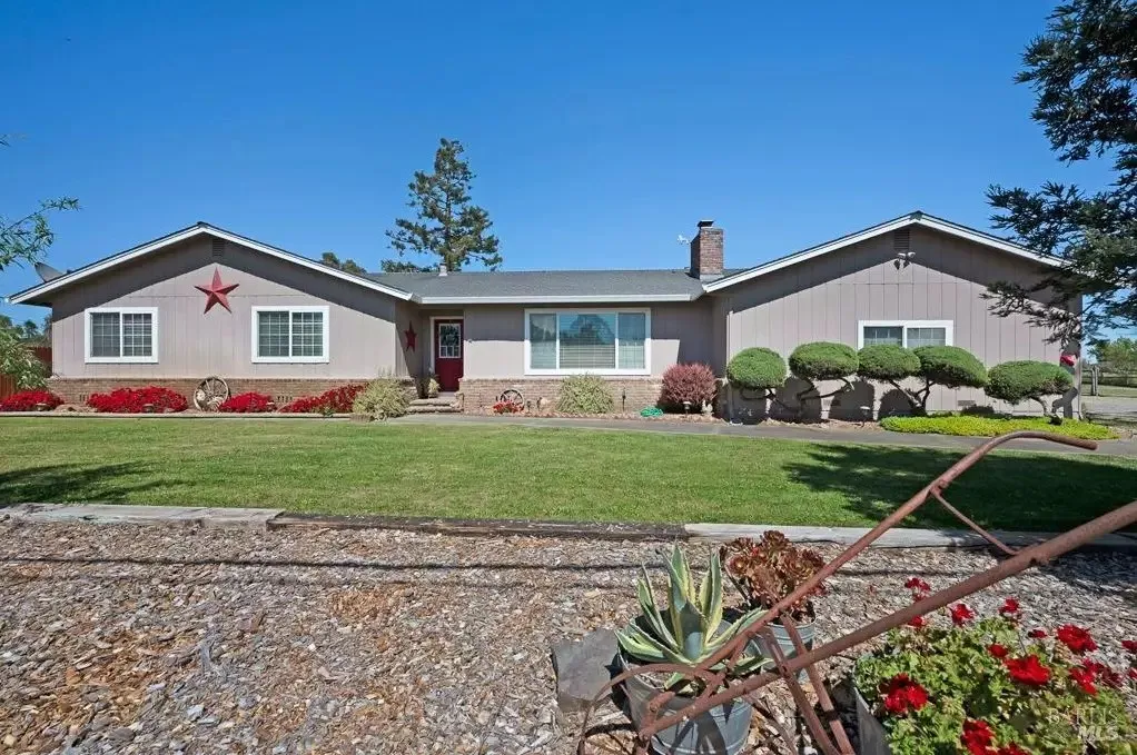 Daytime front exterior with red door and lawn